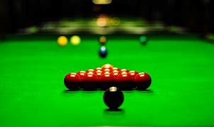 Image of man's arm holding a snooker cue